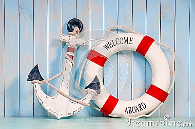 Anchor and life buoy on a background of shabby wall boards