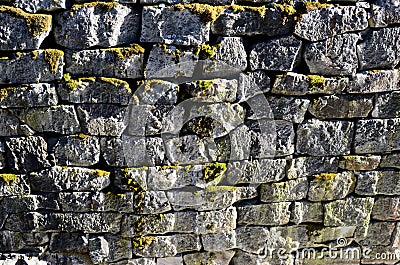 Ancient granite stone wall channel mossy