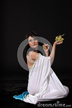 Ancient greece woman with a bunch of grapes