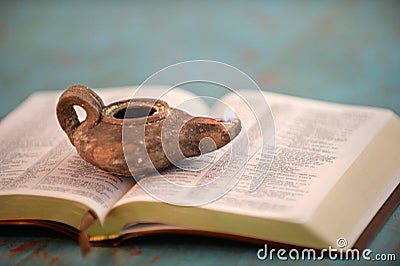 Ancient Oil Lamp on Open Bible