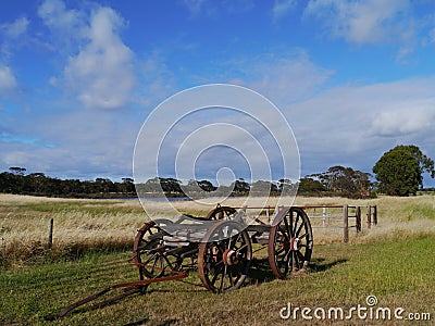 An ancient wooden cart in a field