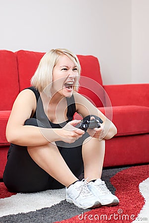 Angry blonde girl playing video games
