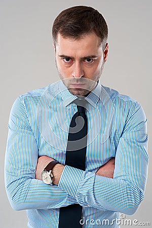 Angry business man with folded hands