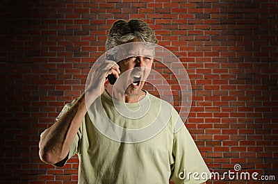 Angry screaming man on a cell phone