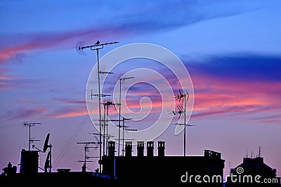 TV antennas at sunset in Milan, Italy