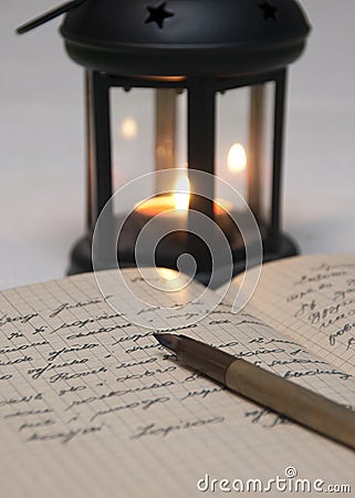 Antique black candlestick, candle and old letter