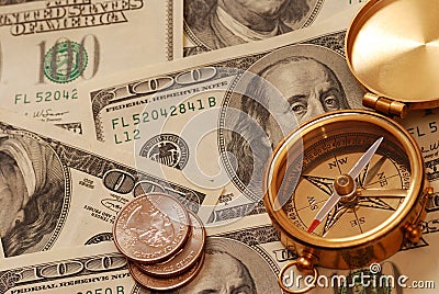 Antique compass over money