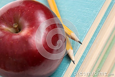 Apple and pencils on books
