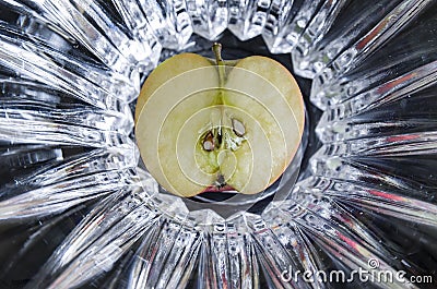 Apple sectioned in half with seeds exposed on abstract background