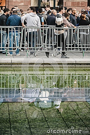 Apple Store with long lines and log reflected