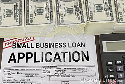 Approved small business loan application form and money