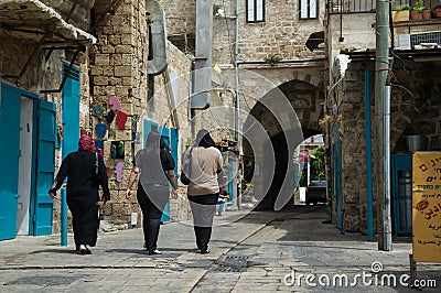 Arab women going on the old street of Akko, Israel