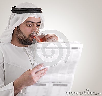 Arabian business man reading newspaper