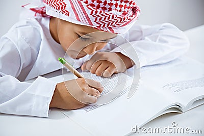 Arabic little boy doing homework