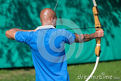 Archer at shooting range with bow and arrows