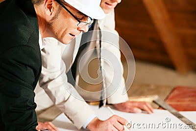 Architect and construction engineer with plan