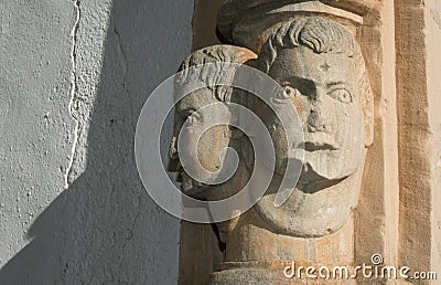 Architectural detail heads on a wall