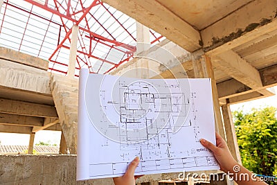 Architecture drawings in hand on house building