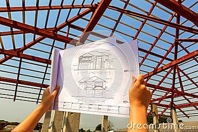 Architecture drawings in hand on house building