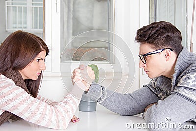 Arm wrestling challenge between a young couple