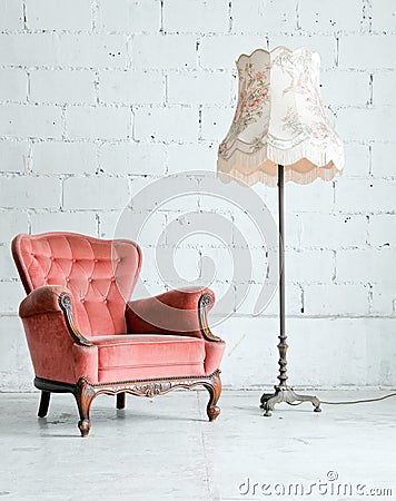 Armchair with desk lamp in vintage room