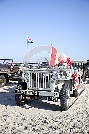 Army jeep of organization Kelly s Heroes riding on beach