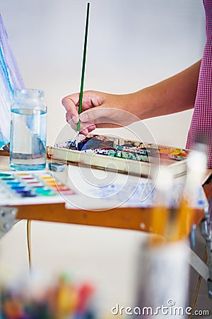 Artist painting picture on canvas