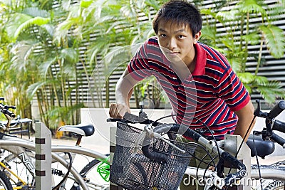 Asia man take bike in bicyle park