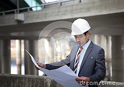 Asian architect on highway construction site