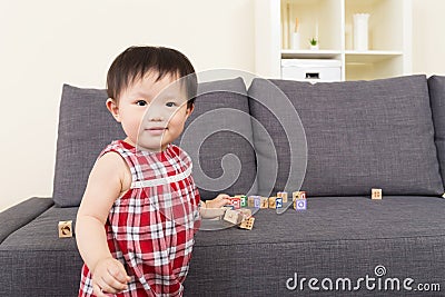 Asian baby girl play with wooden block