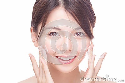 Asian beauty applying cream to face