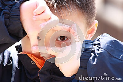 Asian boy act like a photographer