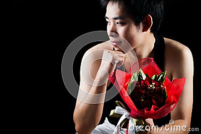 Asian boy with red bouquet in dark background
