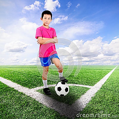 Asian boy with soccer ball at soccer field