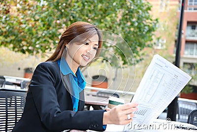 Asian Business Woman Reading Newspaper