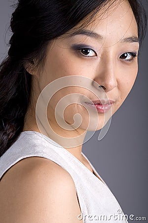 Asian Business Woman in Suit Eyes to Camera