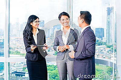 Asian Businesspeople standing in office