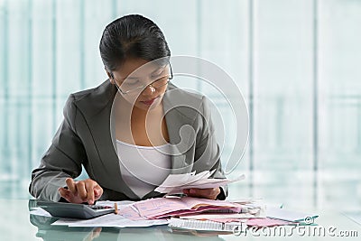 Asian businesswoman calculating bills