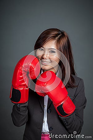Asian businesswoman guard with boxing glove