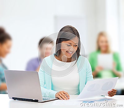 Asian businesswoman with laptop and documents