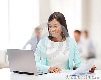 Asian businesswoman with laptop and documents