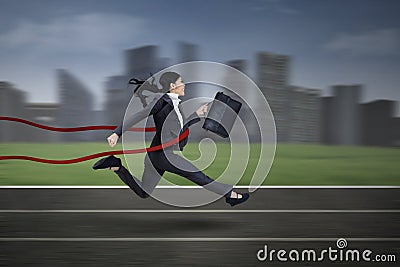 Asian businesswoman winning a race
