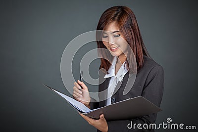 Asian businesswoman working with a pen and folder