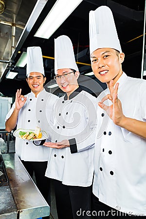 Asian Chefs in hotel restaurant kitchen
