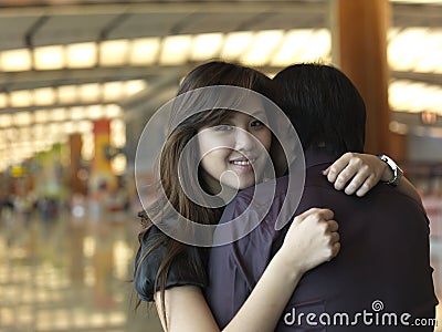 Asian Chinese girl greeted by guy at the airport