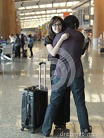 Asian Chinese guy welcoming girl at airport