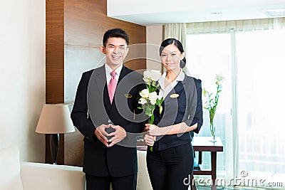 Asian Chinese hotel manager welcoming VIP guests