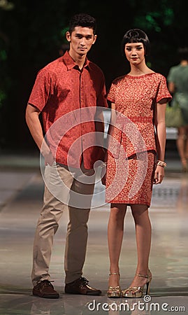 Asian couple model wearing batik at fashion show runway