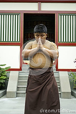 Asian man praying standing