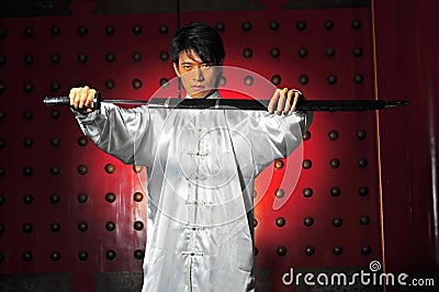 Asian Man Unsheading A Sword